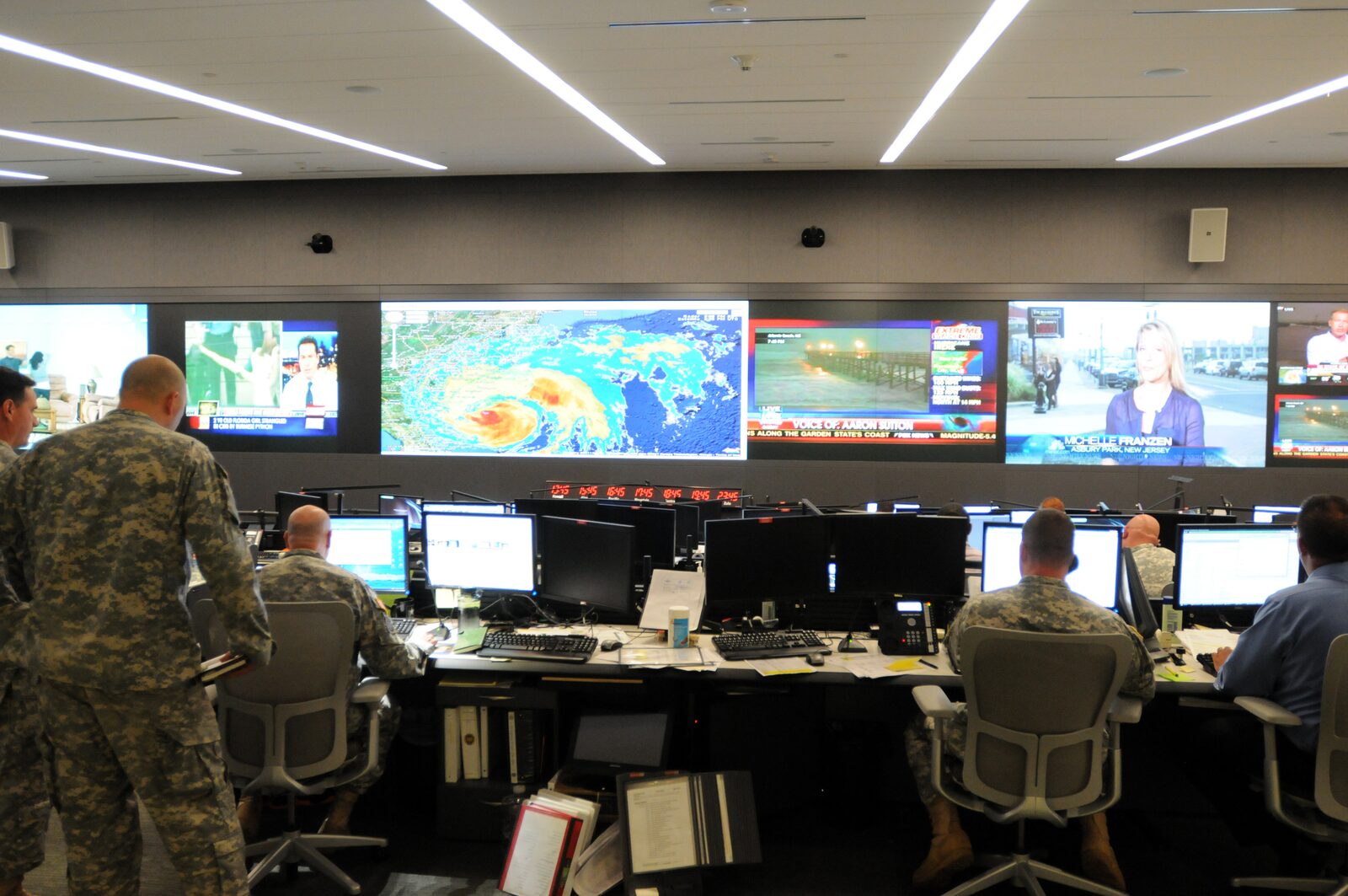 Staff at the National Guard Command Center in Arlington, Virginia, track Hurricane Irene on a wall of live news feeds and weather data, 26 August 2011. Photo: Staff Sgt. Jim Greenhill, U.S. Army, Public domain, via Wikimedia Commons