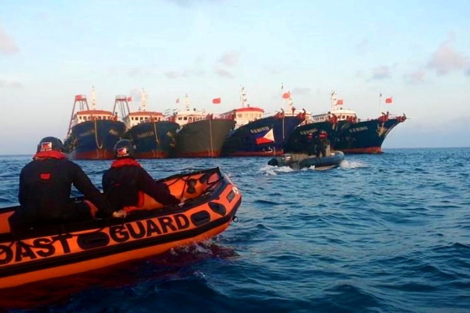 A Philippine Coast Guard boat approaches Chinese-flagged vessels moored at Whitsun Reef (Julian Felipe Reef) in the Spratly Islands, which Manila said were maritime militia, 13 April 2021. Photo: Philippine Coast Guard, Public domain, via Wikimedia Commons